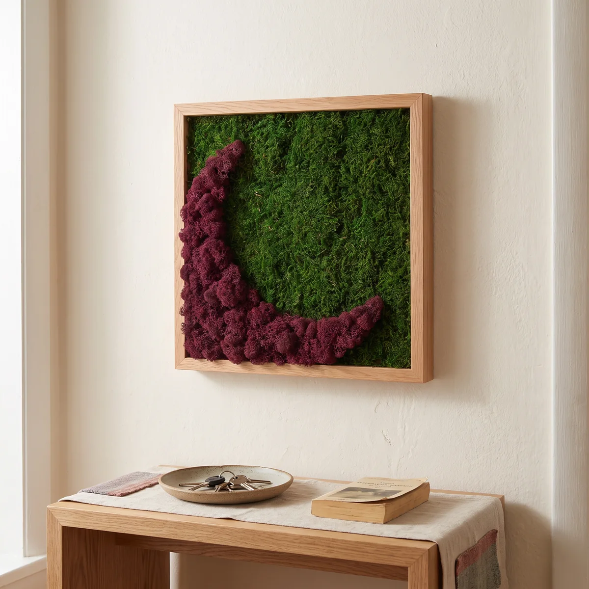 A composition in red and burgundy tones with preserved moss and lichen textures, in a light oak square frame.