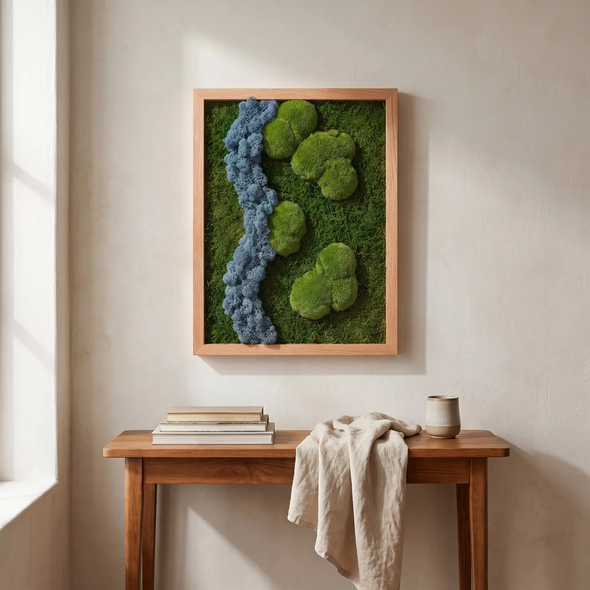 A composition in blue tones with preserved moss and lichen textures, in a light oak portrait frame.